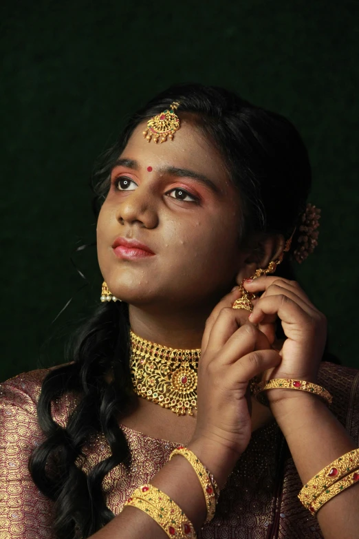 an indian girl wearing a traditional dress looking up