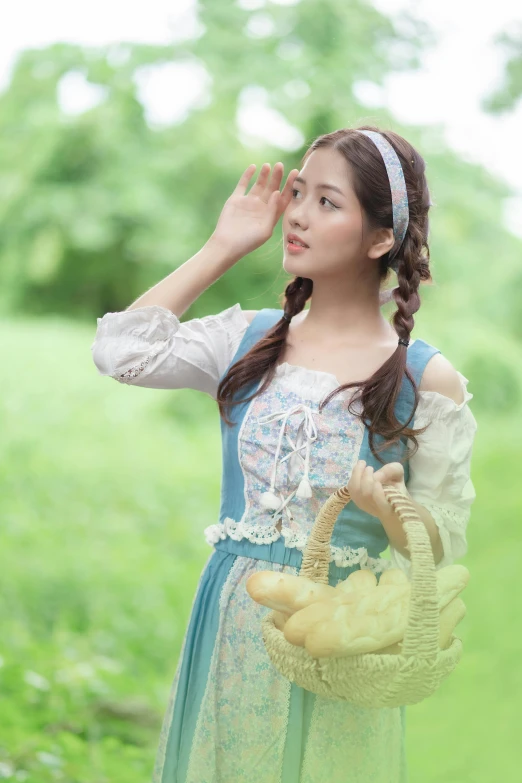 a girl with an elephant basket on her head in the forest