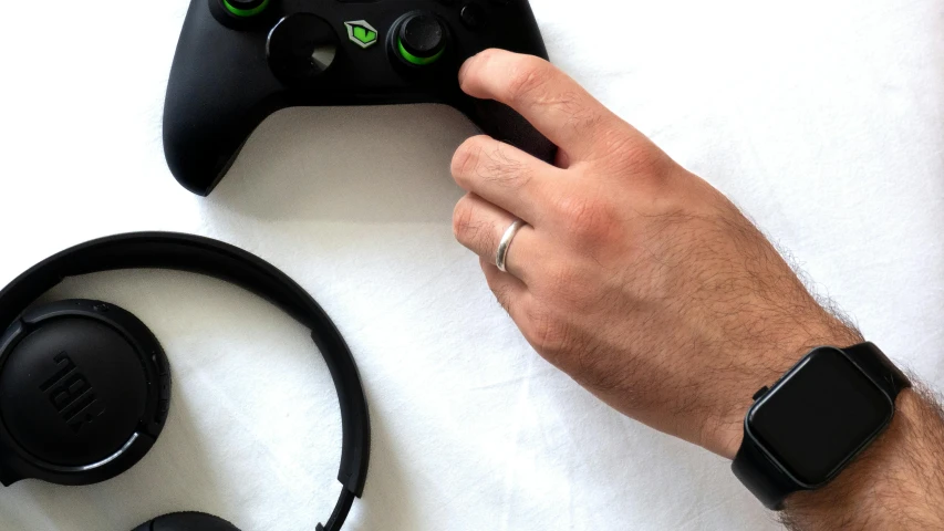 a person holding up a controller for a game system