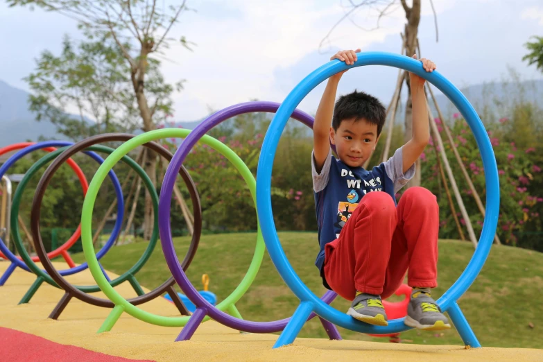 a boy plays in a playground while holding on to the tube