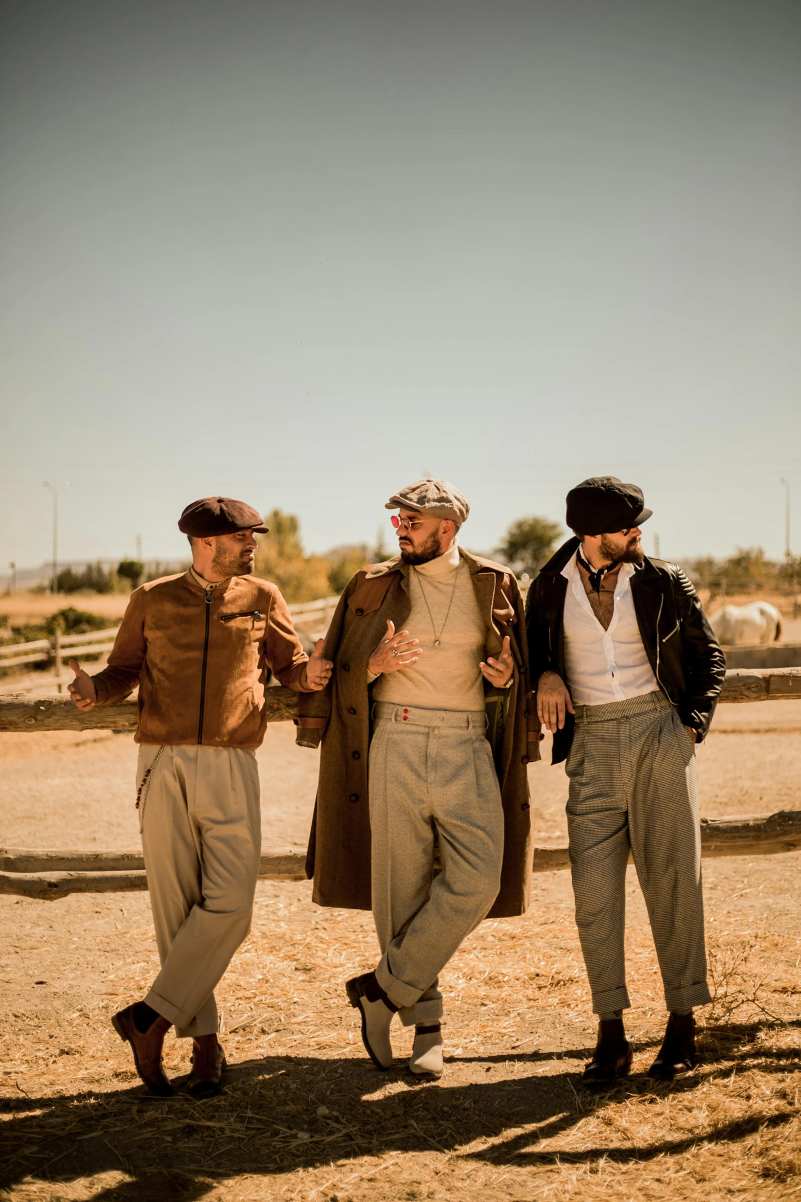 three men stand in the desert holding hands