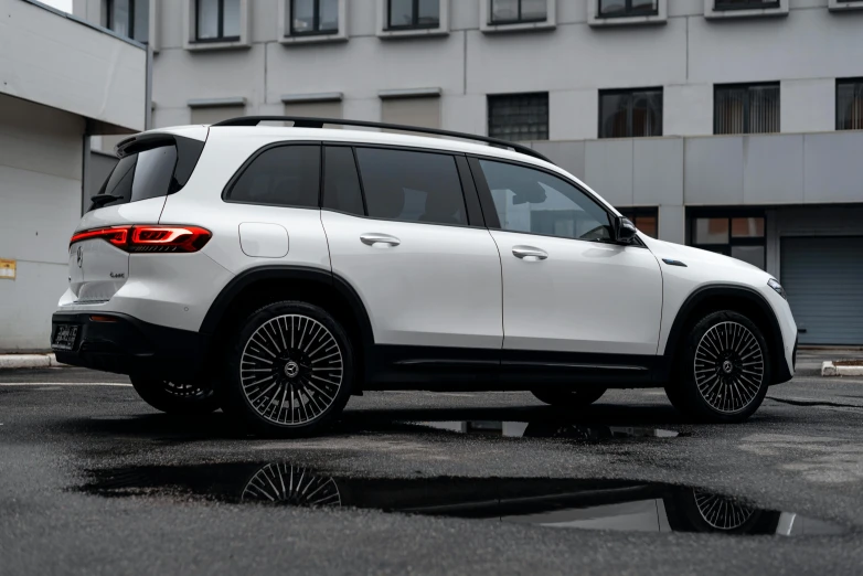 a white suv parked next to a building