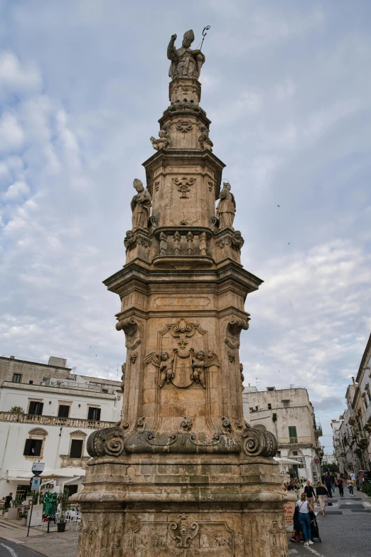 an ornately decorated monument with people standing around