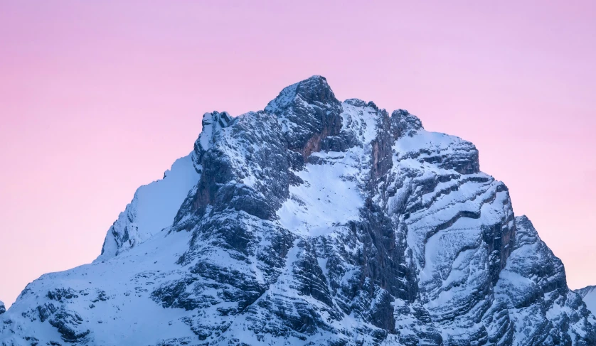 a snowy mountain that has a large mountain top