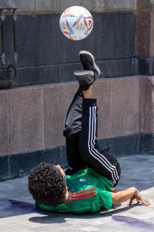 a man with his head in the air above another man on the ground