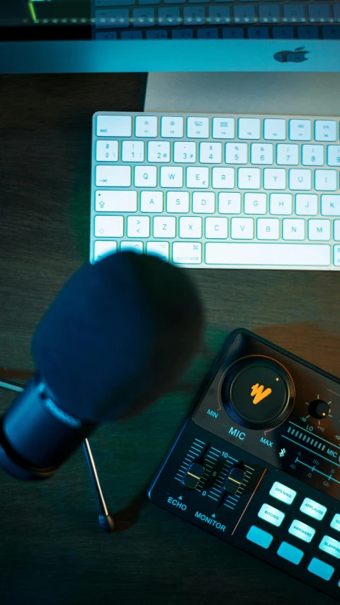 an empty microphone with a keyboard and laptop nearby