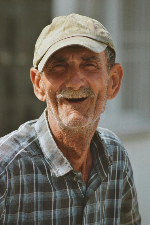 a close up of a man wearing a cap