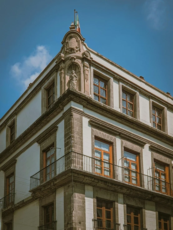 a large white building with an open balcony