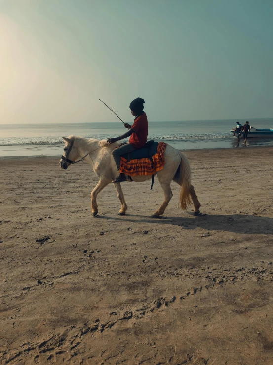 the man is riding his horse at the beach