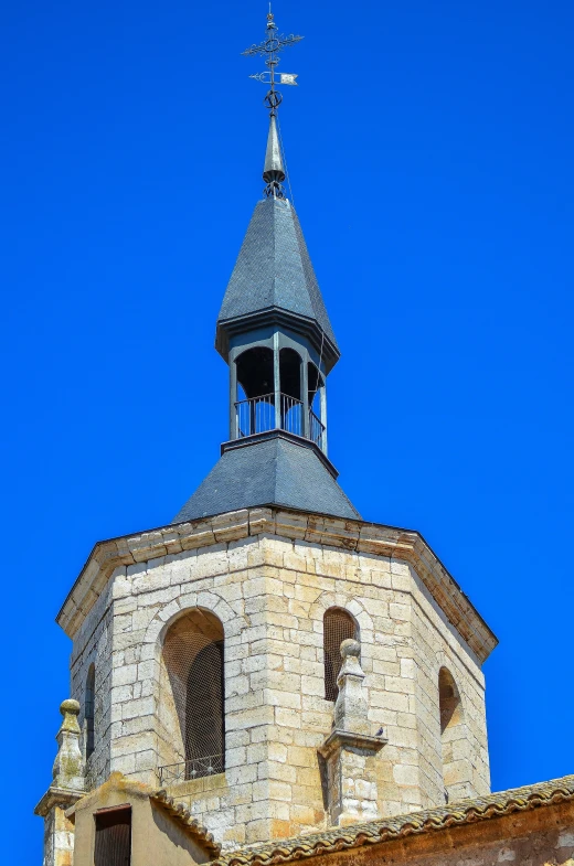 the top of an old stone building with a clock at the end