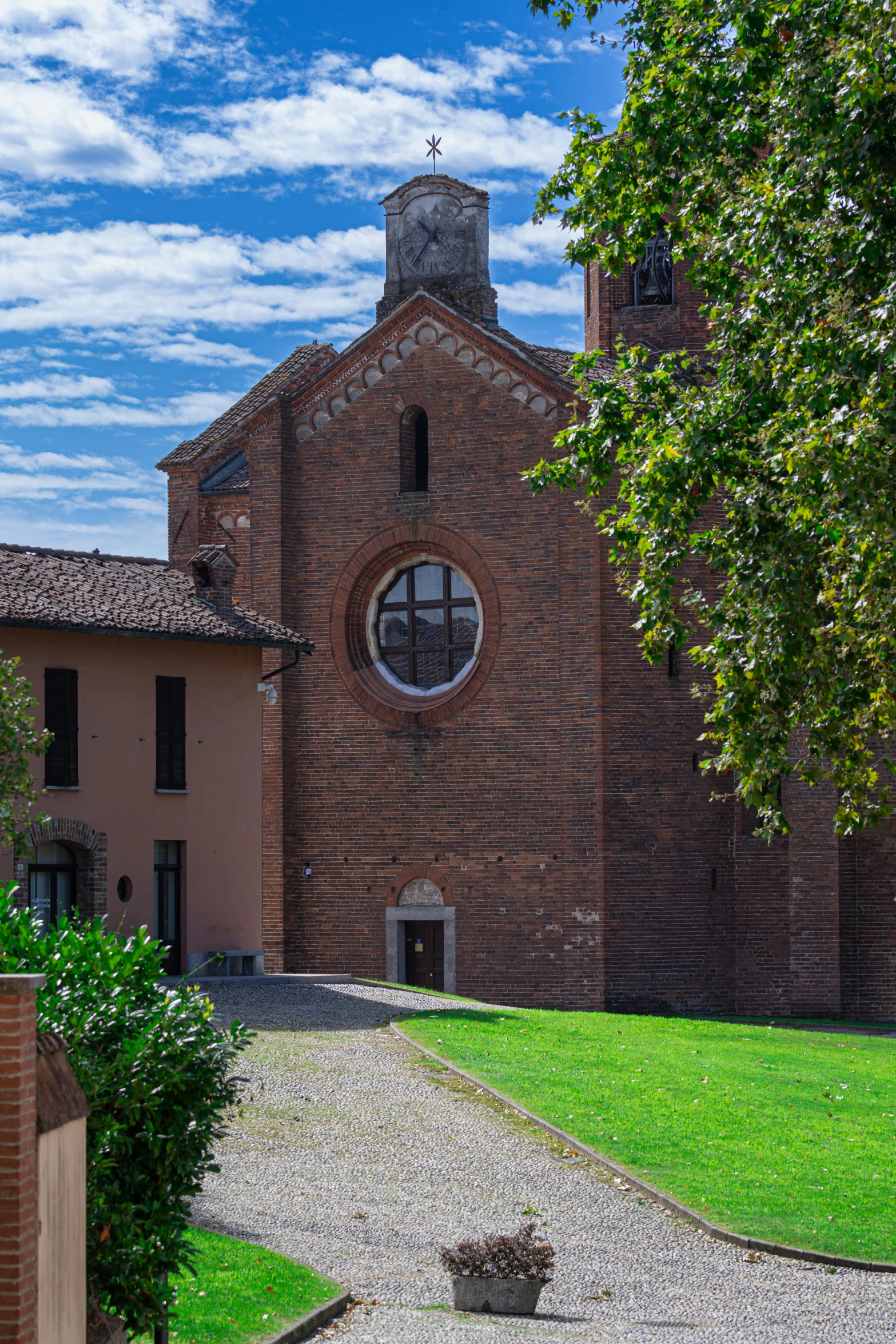 a church with round windows is in the middle of the park