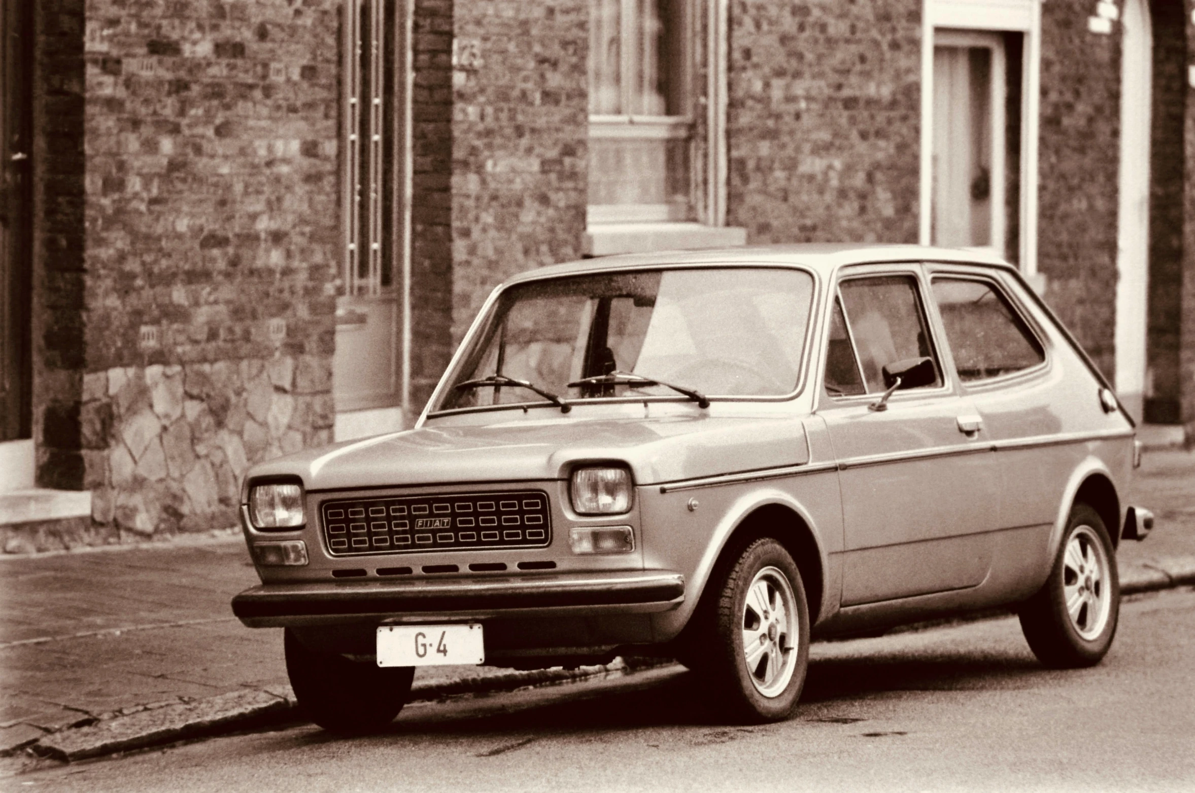 an old car is parked on the side of a street