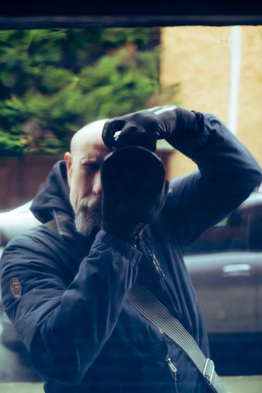 a man looks out the window of a car