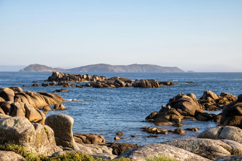 a group of rocks on top of a body of water