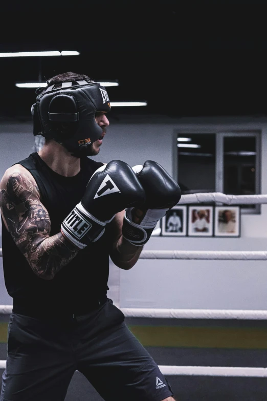 a man standing in a room with boxing gloves