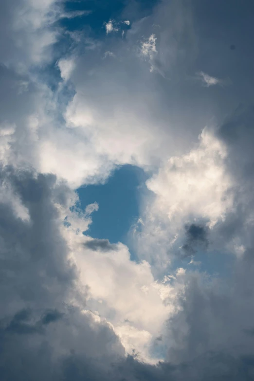 a plane flies in the clouds and is getting ready to land