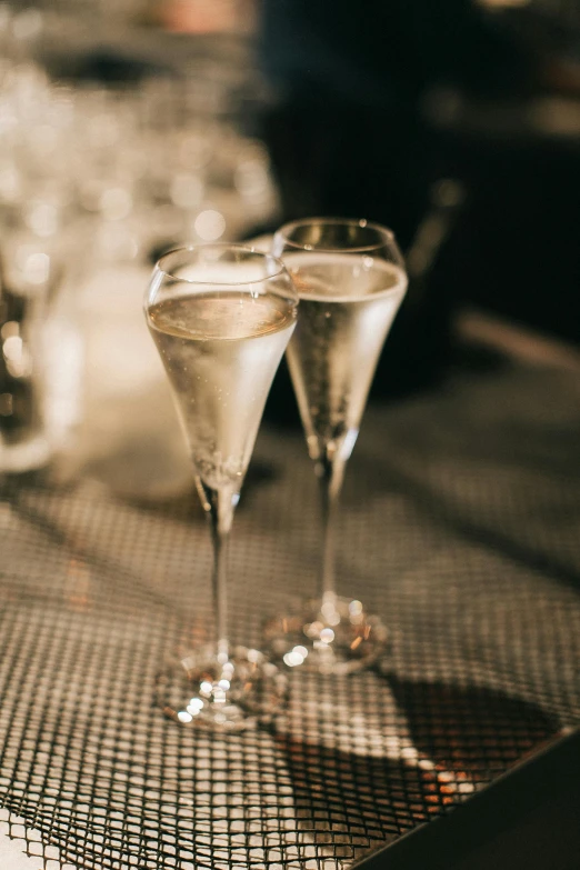 three glasses with champagne are sitting on a table