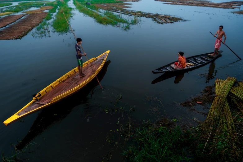 there are two people on small boats in the water