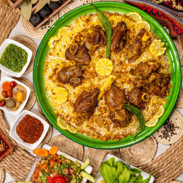 an overhead view of various dishes displayed on woven rug