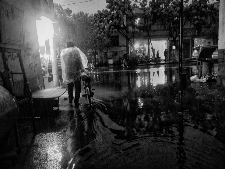 a person with an umbrella riding a bike