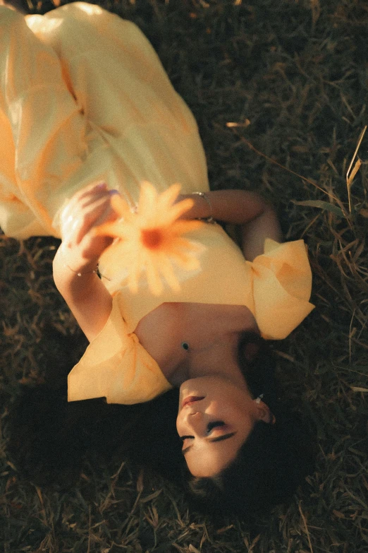 a dummy laying on the grass wearing a white top