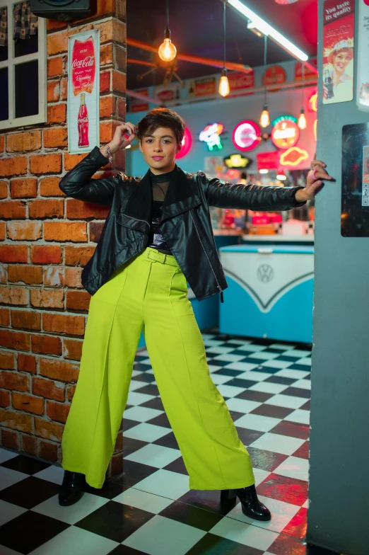 a woman posing with her arms crossed near a machine