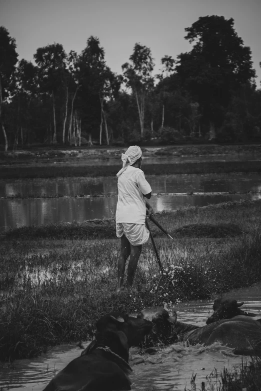 a black and white image of a person in the water with a boat