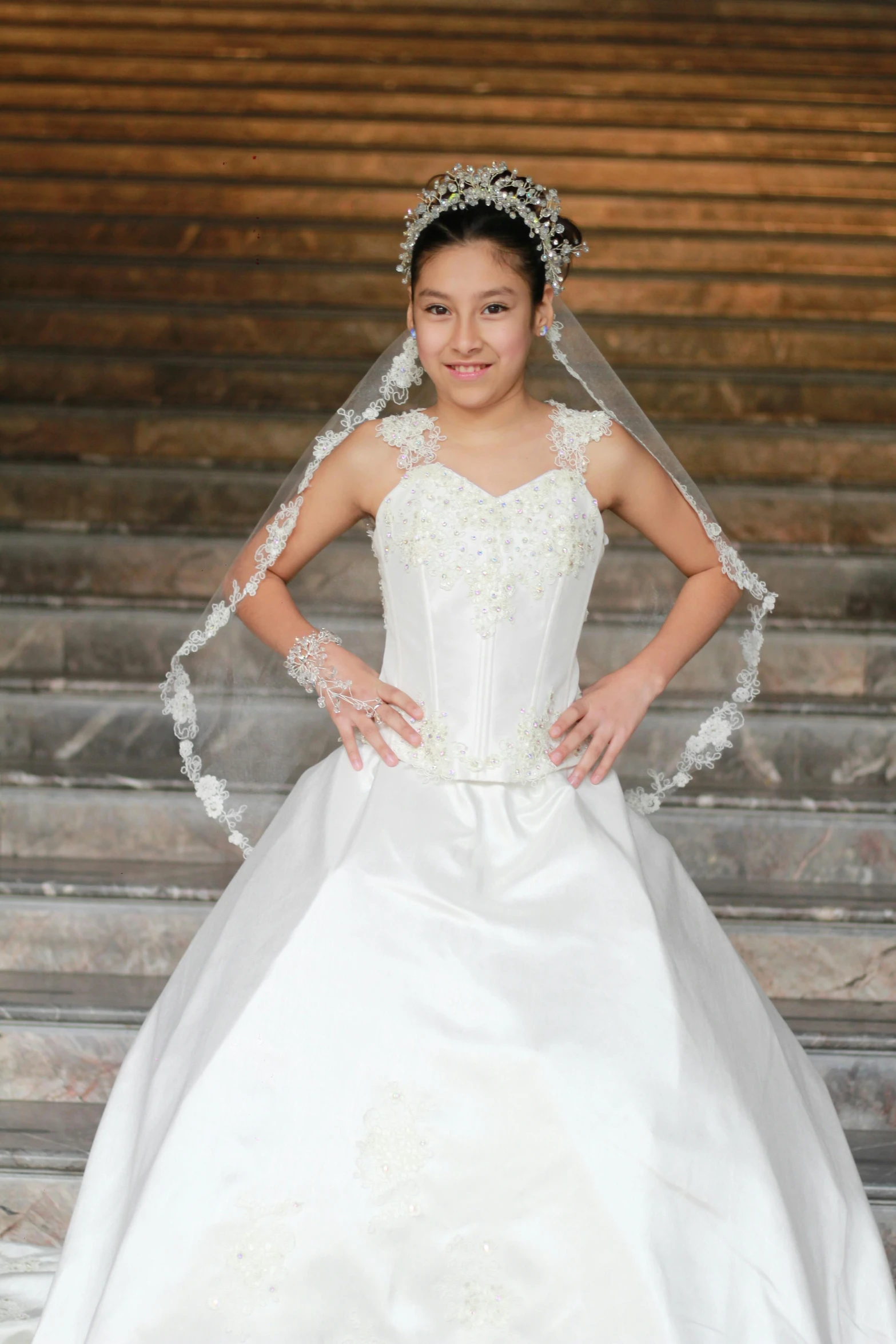 a woman in a white gown standing next to steps