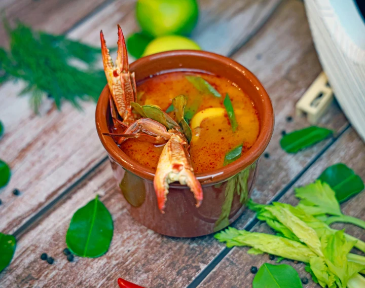 a bowl filled with a vegetable and seafood soup