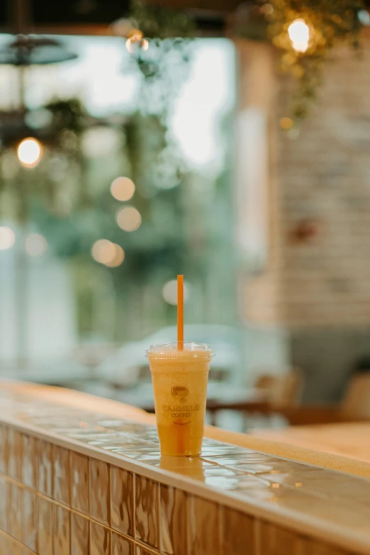 the drink has a straw in it and is placed on the counter