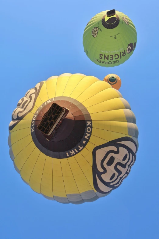 three  air balloons fly in the sky