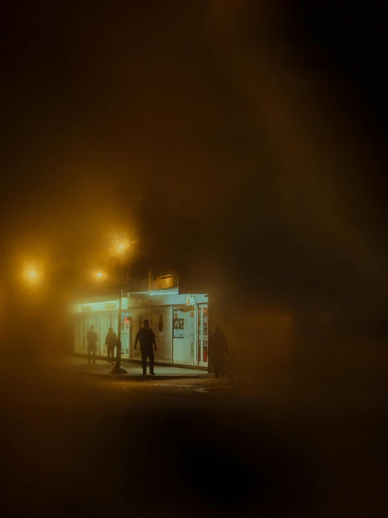 a man in a dark room with a building behind him