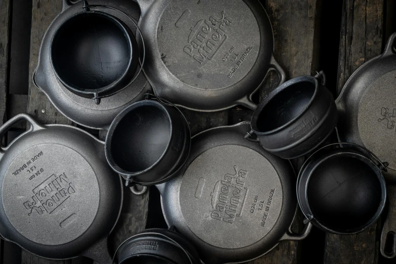 old pot on wooden pallet with dirty lids