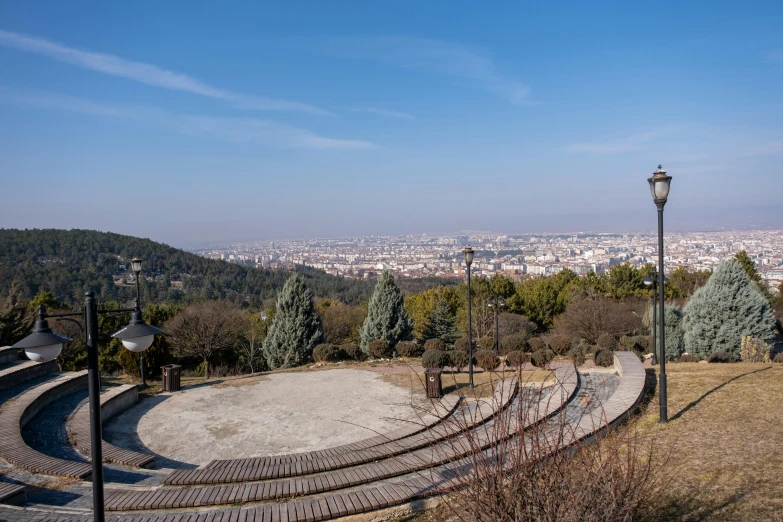 a small park with steps and a hill overlooking the city