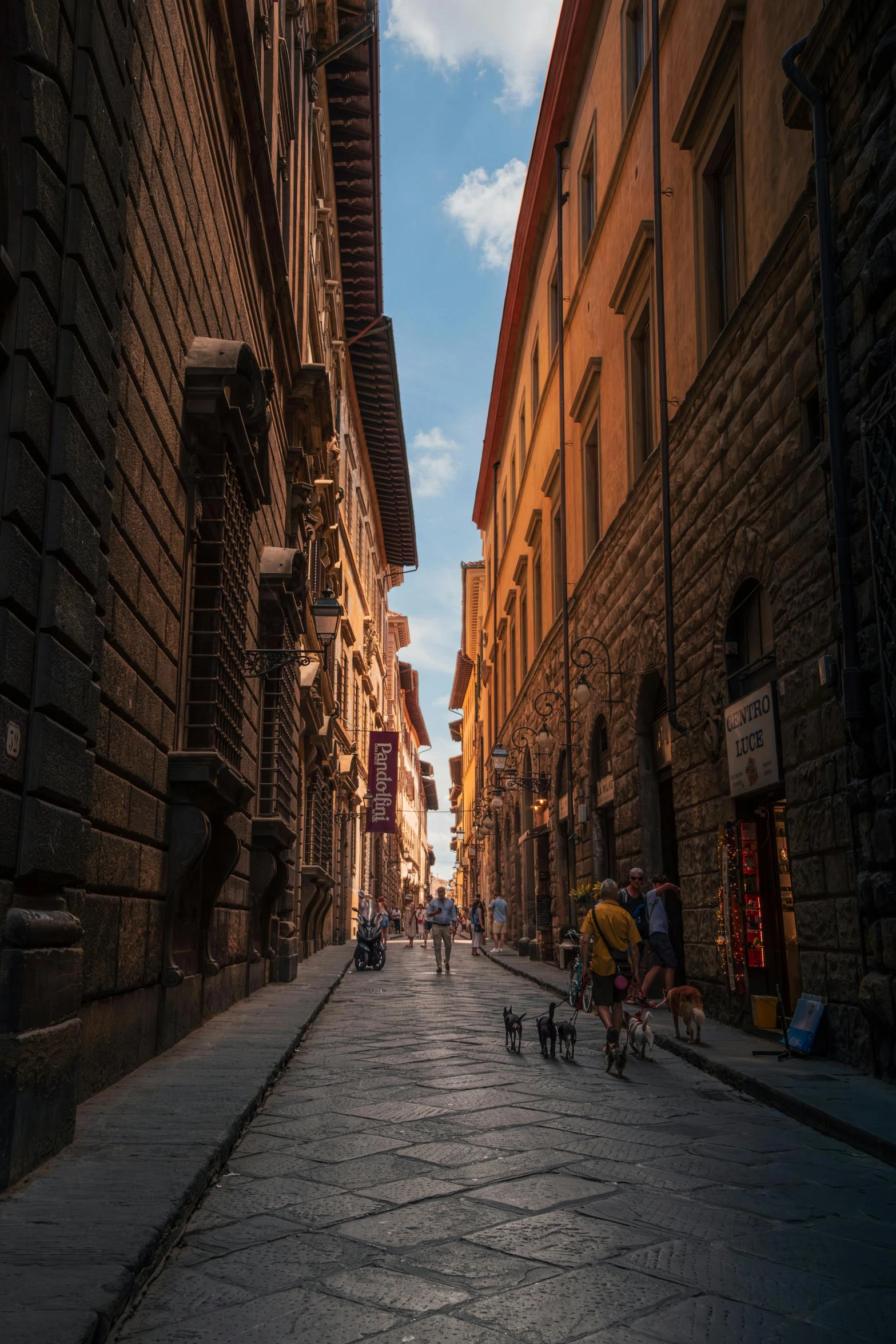 a street is shown with several people walking