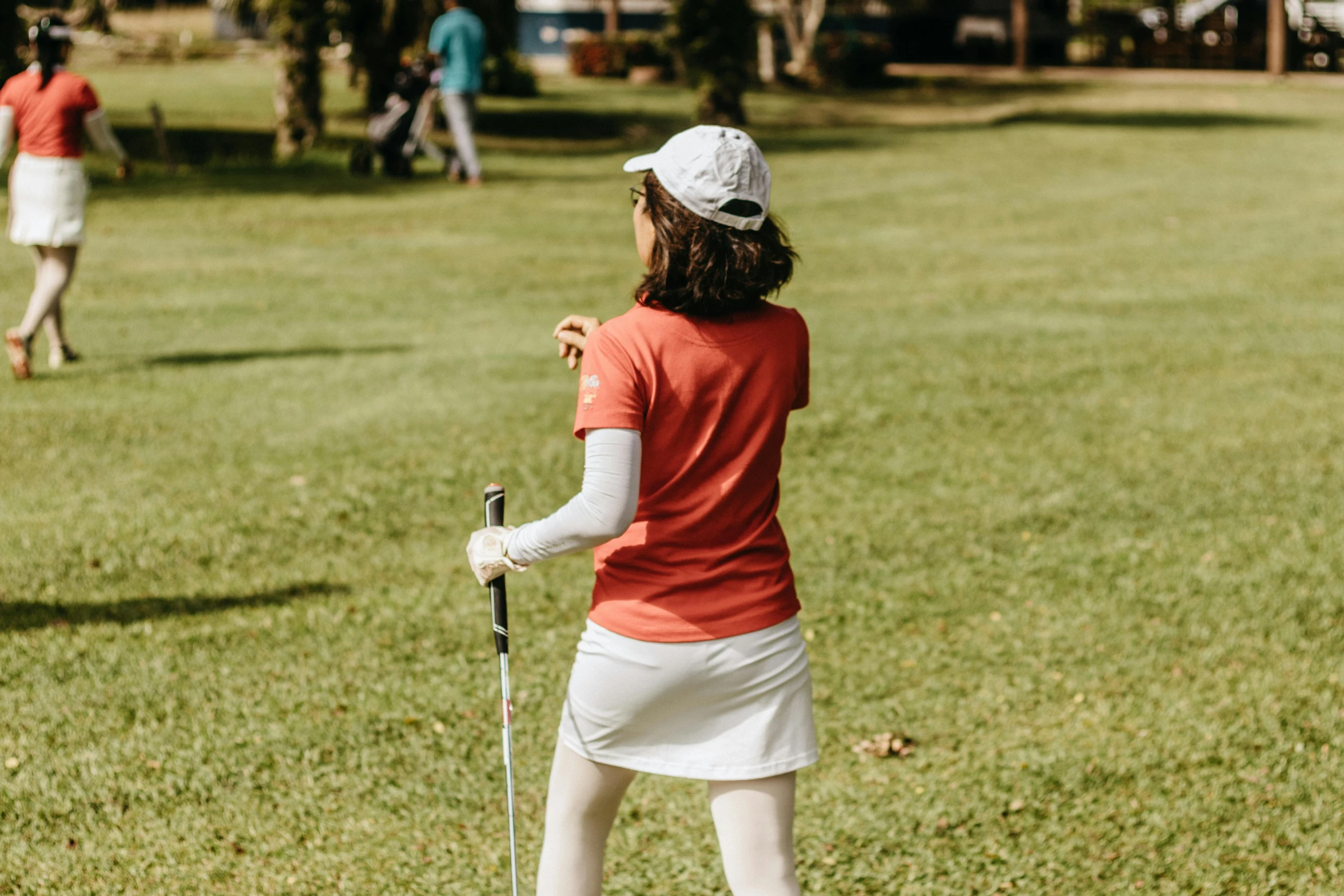 an elderly lady on a tee line golf course