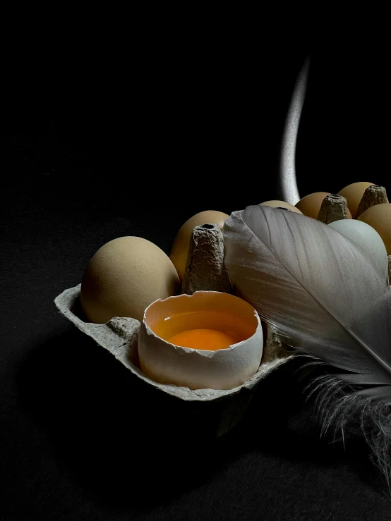 a white plate topped with eggs next to a feathers tail