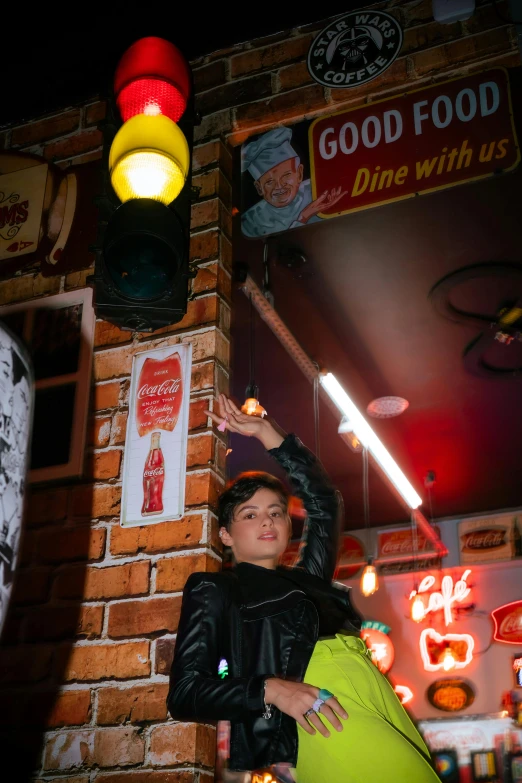 a person standing by a brick wall at night