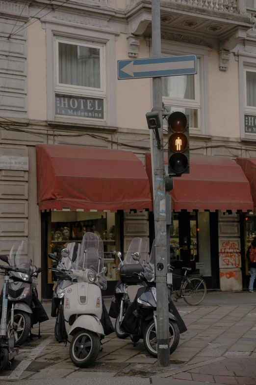 motorcycles are parked outside a el next to a street light