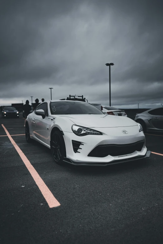 a white sports car parked in the parking lot