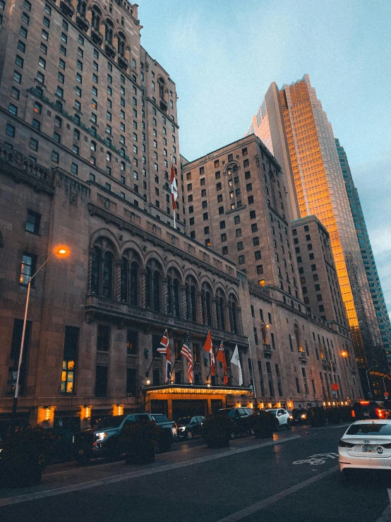 a car driving down the street next to tall buildings