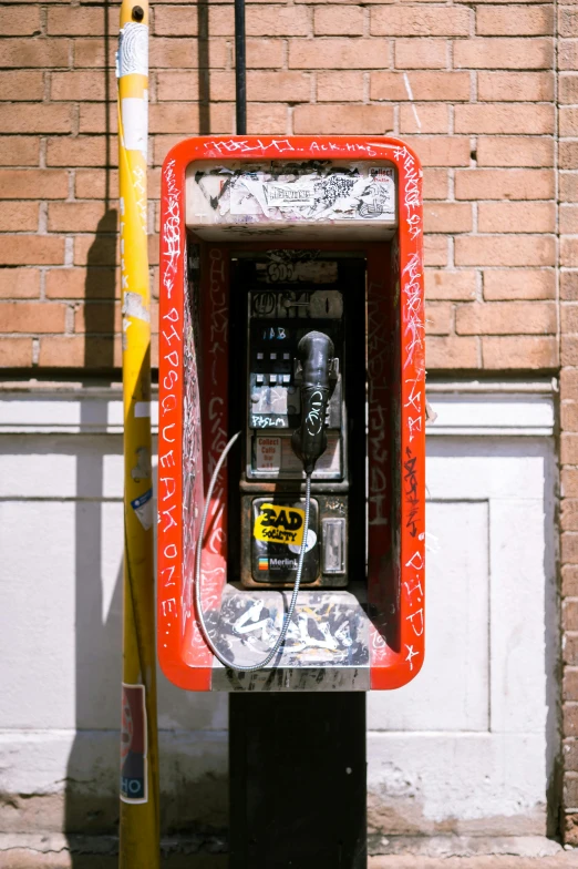 an old style red phone with a red frame