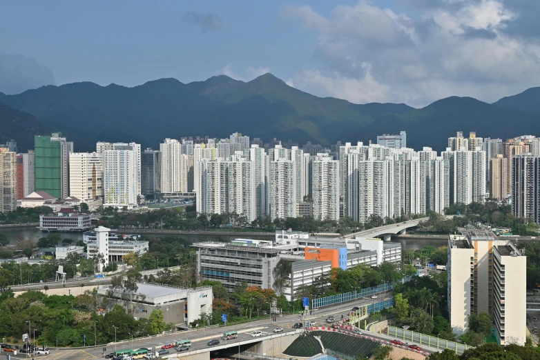 a city area with buildings, and mountains in the background