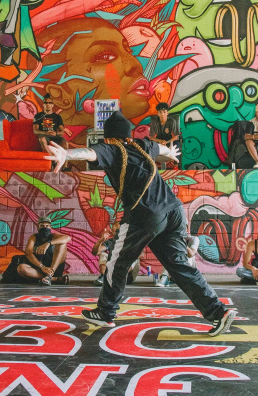 a skateboarder wearing black performing on a brightly colored background