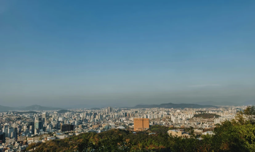 an airplane flies in the clear sky above a city