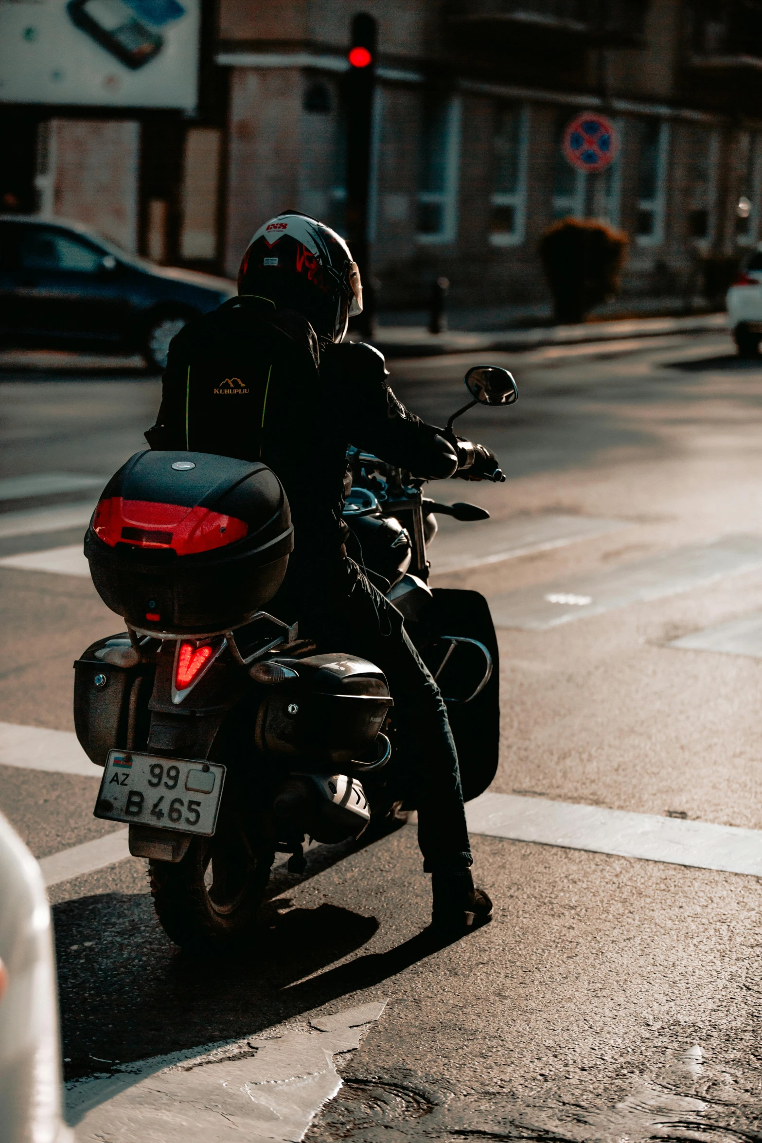 a motorcycle rider is riding down the street