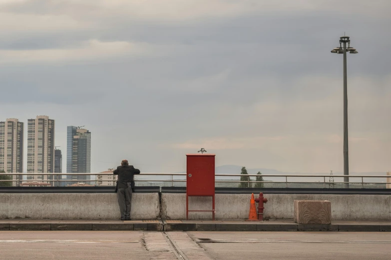 two men standing near a wall with a large object on it