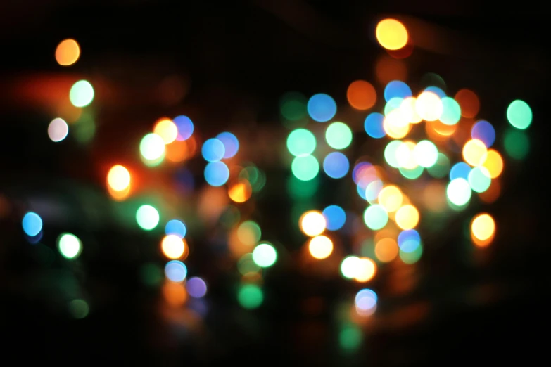 colorful lights are arranged on the dark surface