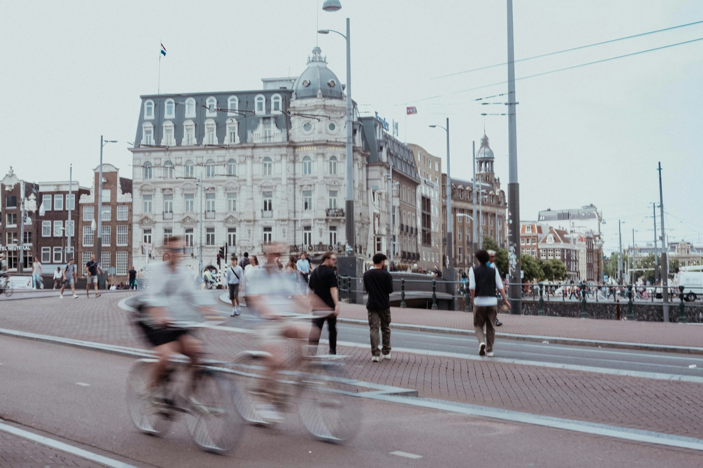 people are on bikes walking and crossing a street