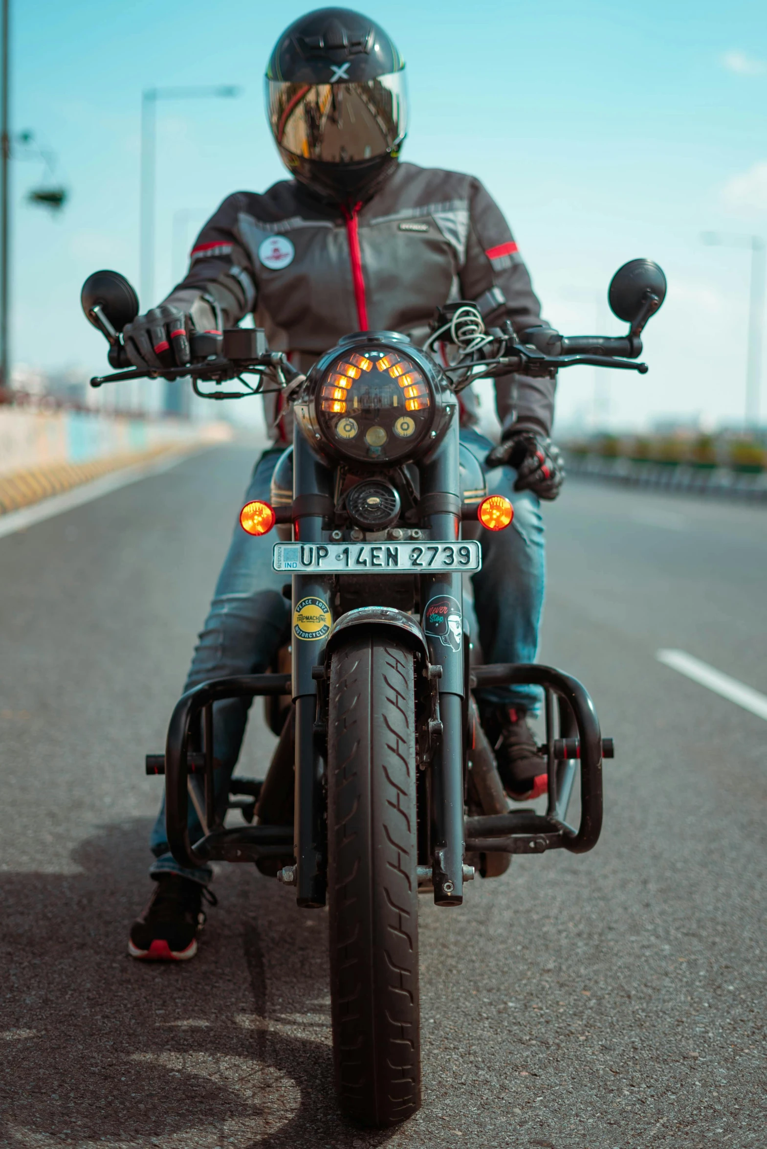 a man riding on the back of a motorcycle down a street